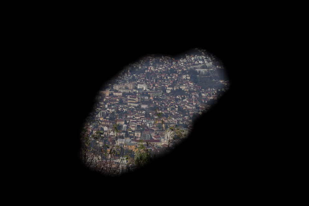 A view of the city of Sarajevo through a hole in a war-damaged building that once marked the front line during the Bosnian conflict (1992-95). (REUTERS/Amel Emric)